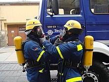 Gegenseitig überprüfen zwei Helfer den korrekten Anschluss der Atemschutzgeräte (Foto: THW/Anja Villwock)